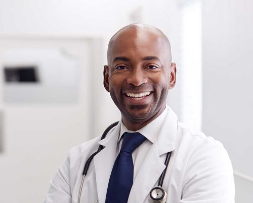 portrait-of-mature-male-doctor-wearing-white-coat--H49URGD-b